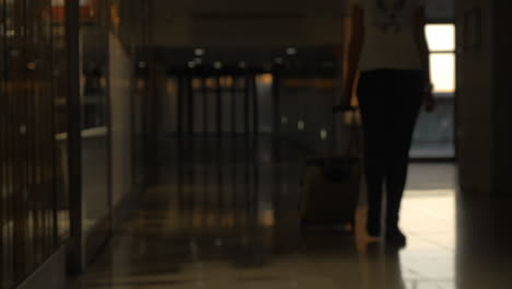 Woman-with-suitcase-walking-at-the-airport