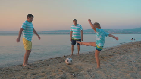 Men-and-Boy-Playing-Football-on-the-Beach