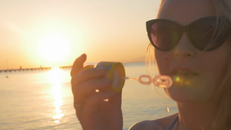 Woman-Blowing-Soap-Bubbles-at-Sunset
