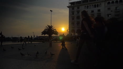People-walking-and-playing-on-the-square-on-sunset