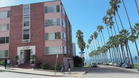 Straße-In-La-Jolla-Mit-Palmen,-Blick-Auf-Das-Meer,-Gebäude-Und-Menschen