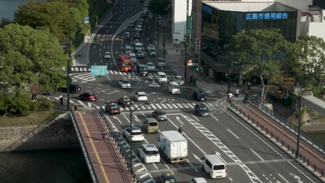 Overlooking-traffic-in-Hiroshima-city-at-a-red-light,-urban-cityscape-static-shot