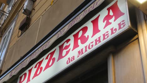 Detail-of-the-facade-of-the-famous-pizzeria-of-the-Michele-chain,-considered-as-the-first-pizzeria's-in-the-world,-Naples,-Spain