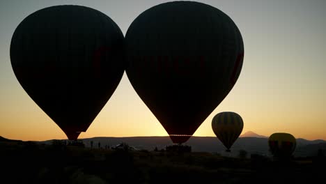 Temprano-En-La-Mañana,-Amanecer,-Vuelo,-Siluetas,-Despegue-De-Globos-Aerostáticos.