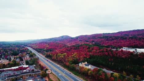 Aerial-view-capturing-the-vibrant-fall-foliage-blanketing-the-hills-of-Dalton,-Georgia