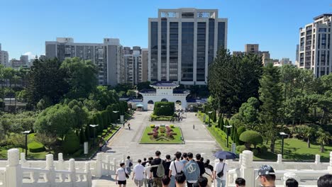 Tourists-walk-down-the-stairs-at-Chiang-Kai-shek-Memorial-Hall,-a-national-monument-in-Taipei,-Taiwan