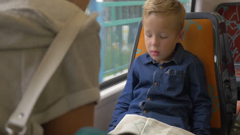 Child-with-map-in-commuter-train