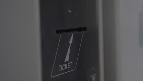 Taking-ticket-from-self-service-machine