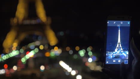Mobile-photo-of-illuminated-Eiffel-Tower-at-night