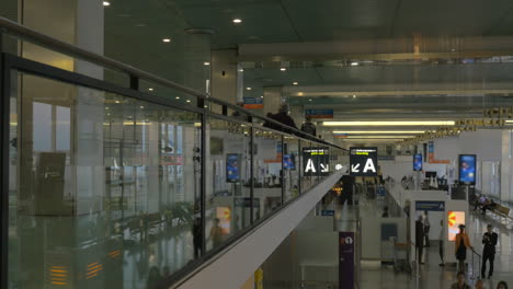 Airport-hall-with-passengers-shot-from-back