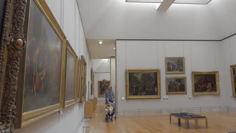 Young-mother-and-little-child-visiting-Louvre