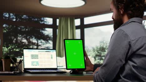 Company-CEO-examines-greenscreen-templates-on-tablet