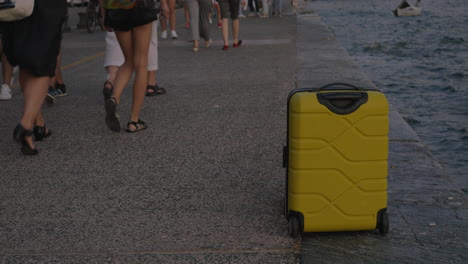 Suitcase-on-wheels-stands-on-sea-coast-in-city-of-Thessaloniki-Greece