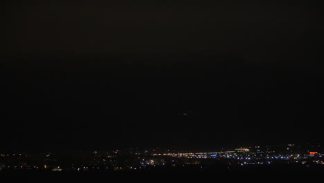 Illuminated-night-city-and-lightning-flashes