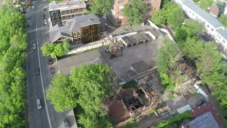 Aerial-shot-of-street-with-car-traffic-and-ruined-house