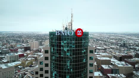 High-Altitude-4K-Drone-Shot-of-the-Sign-Exterior-High-rise-Skyscraper-Bank-of-Montreal-BMO-Head-Office-in-Downtown-Winnipeg-Manitoba-Canada