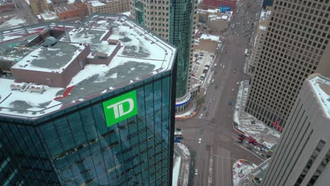 High-Altitude-4K-Winter-Northern-Drone-Shot-of-the-Sign-Exterior-High-rise-Skyscraper-TD-Toronto-Dominion-Bank-Head-Office-with-Portage-Main-Street-in-Downtown-Winnipeg-Manitoba-Canada