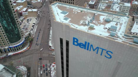 High-Altitude-4K-Winter-Northern-Drone-Shot-of-the-Sign-Exterior-High-rise-Skyscraper-Bell-MTS-Telecommunications-Company-Head-Office-in-Downtown-Winnipeg-Manitoba-Canada