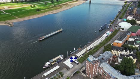 Cargo-vessel-travelling-along-the-river-Rhine,-Düsseldorf,-Germany