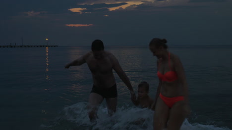 Family-are-swimming-in-the-sea-after-sunset-Piraeus-Greece