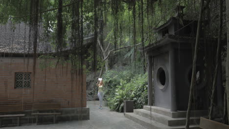 Woman-with-pad-taking-shots-of-pagoda-in-Vietnam