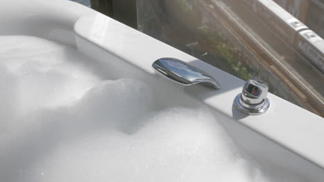 Preparing-relaxing-bath-with-foam