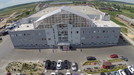 Aerial-view-of-building-outside-the-town-and-parked-cars