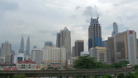 View-of-train-on-the-foreground-and-modern-buildings-skyscraper-on-the-background-Kuala-Lumpur-Malaysia