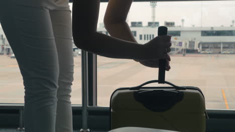 Young-girl-in-Bangkok-Thailand-at-the-airport-weighing-the-suitcase-with-luggage-and-goes