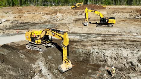 Excavators-With-Power-Shovel-Scooping-Soil-On-The-Ground-In-Preparation-For-The-Construction