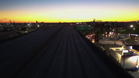 Aerial-view-over-the-empty-LA-I-10,-revealing-a-road-block-and-a-queue-of-cars