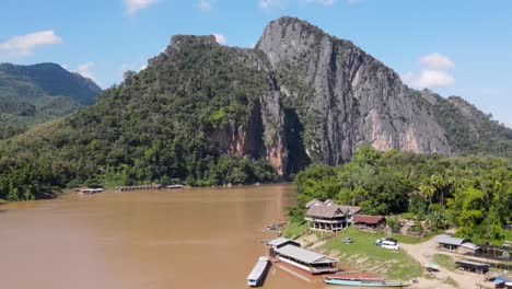 Aerial-View-Of-Caves-On-Cliff-Face-Beside-Mekong-River-In-Luang-Prabang