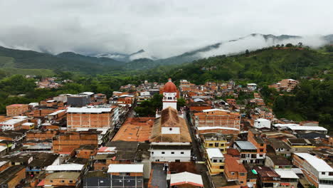 Aerial-view-over-the-Saint-Raphael's-Church-in-cloudy-San-Rafael,-Colombia