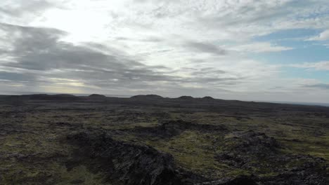 Aerial-of-volcanic-landscape-in-Iceland,-with-cloudy-sky