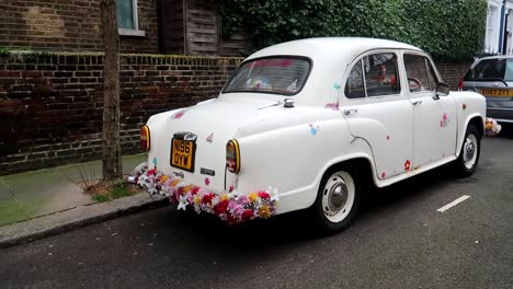 White-car-decorated-with-floral-motifs-parked-near-Portobello-Road-Market,-London