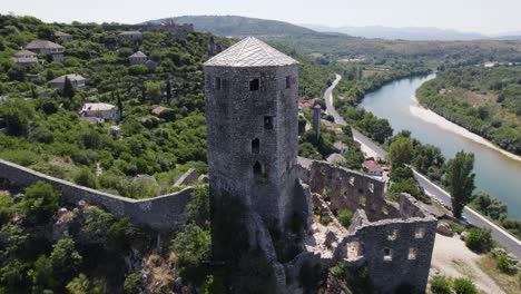 Aerial:-Počitelj-Citadel-Overlooks-Neretva-River,-Bosnia-and-Herzegovina
