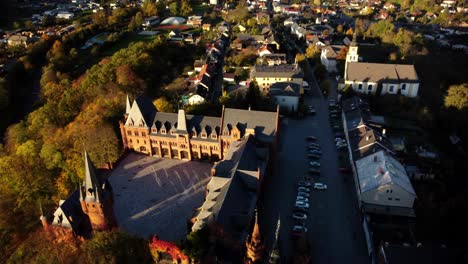Aerial-View-of-Hradec-nad-Moravici-Red-Castle-And-Town-During-Sunset-In-Opava,-Czech-Republic