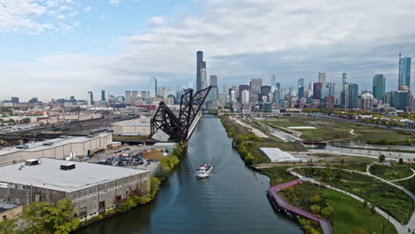 Aerial-view-over-a-ferry-on-the-south-branch-of-the-Chicago-river,-fall-in-USA