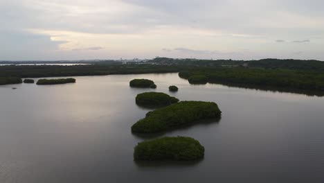 Calming-aerial-drone-shot-of-a-small-group-of-islands-on-a-perfectly-still-body-of-water-on-a-late-afternoon-in-Mexico