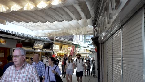 Tourists-walking-around-the-famous-Miyajima-Omotesandō-Shopping-Street