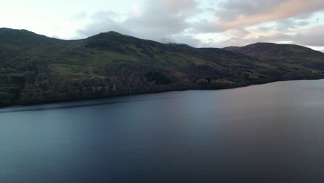 Aerial-view-of-a-beautiful-sunrise-in-the-Scottish-Highlands-at-Loch-Earn--Camera-panning-to-the-righ