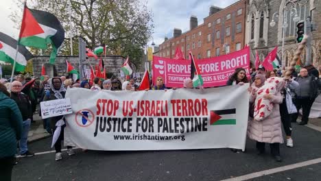 People-holding-a-banner-up-at-a-protest-for-Palestine