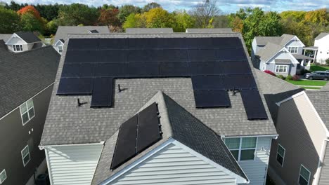 Solar-panels-on-shingle-roof-of-residential-home-in-American-neighborhood