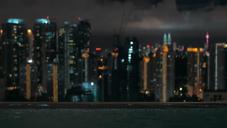 Night-view-of-wave-on-water-on-foreground-and-city-landscape-Kuala-Lumpur-Malaysia