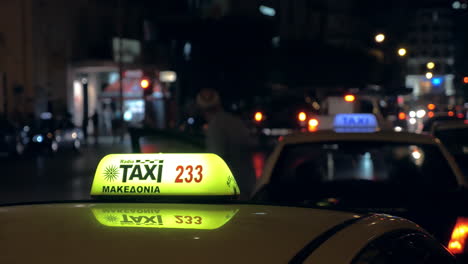 In-the-evening-on-a-busy-road-going-cars-and-close-up-seen-checker-of-taxi