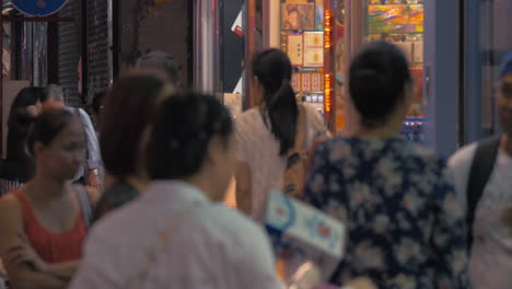 On-a-busy-city-street-walking-people-and-seen-shop-window