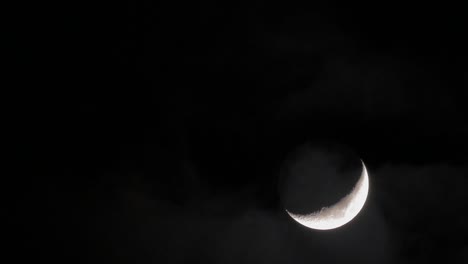 In-night-sky-seen-crescent-and-passing-clouds