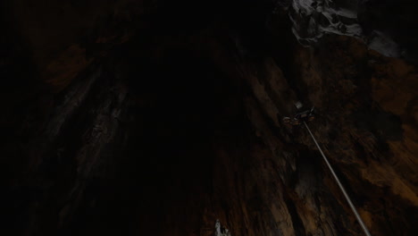 In-Batu-Caves-seen-cave-with-stalactite-and-walking-tourists-photographing-on-mobile-phone-landmark