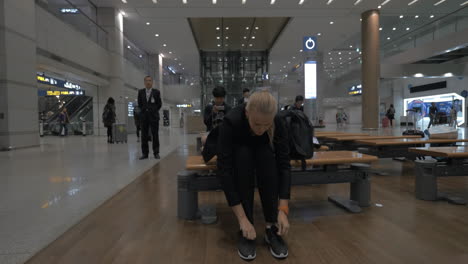 Woman-lying-on-the-bench-in-the-airport-of-Seoul-South-Korea