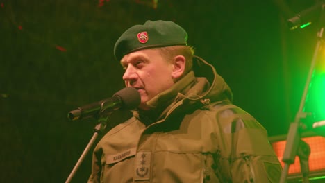 Lithuanian-defence-and-army-professional-talking-on-stage-in-microphone